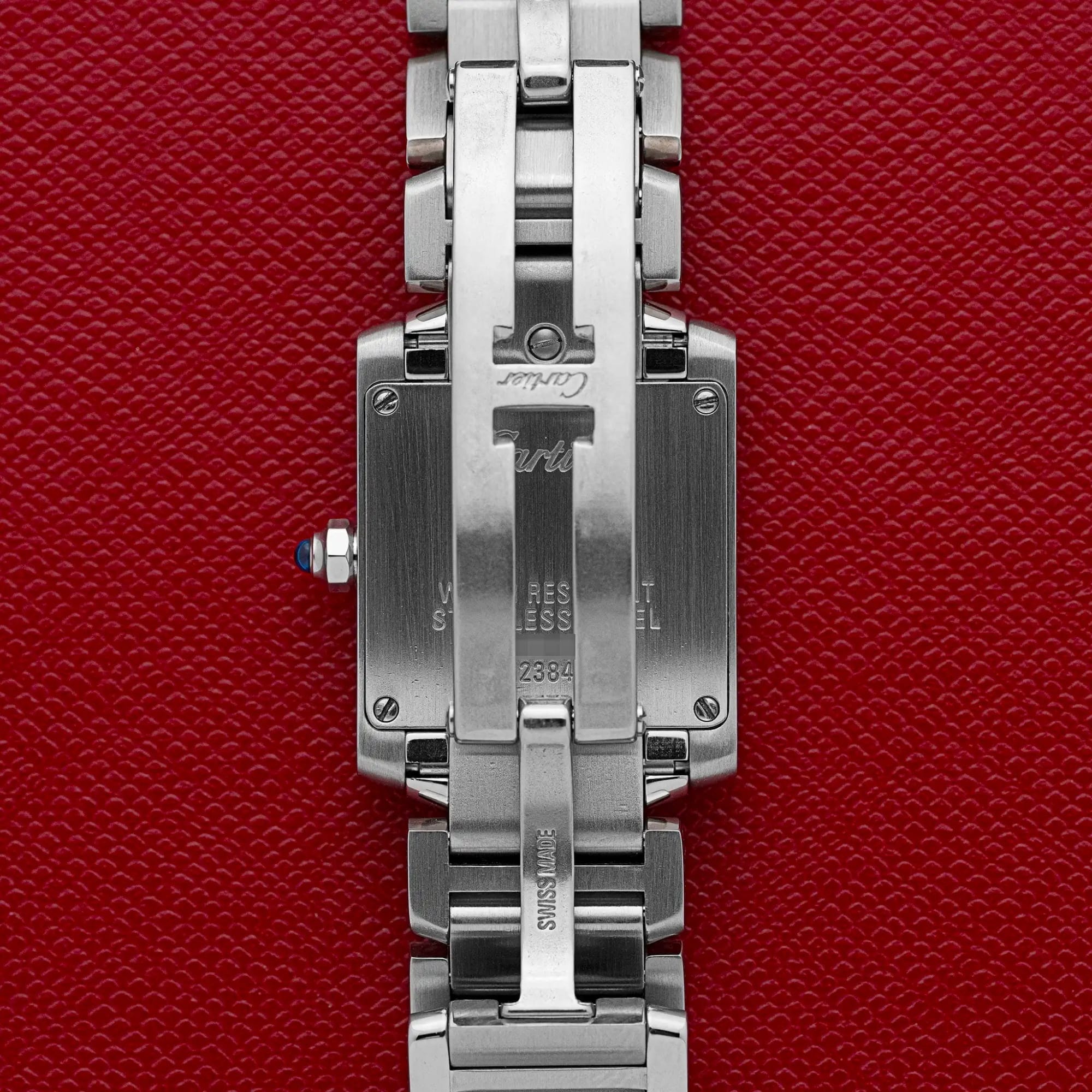 Cartier Tank Française 2384 caseback showing the reference number, Cartier signature, and stainless steel marking.