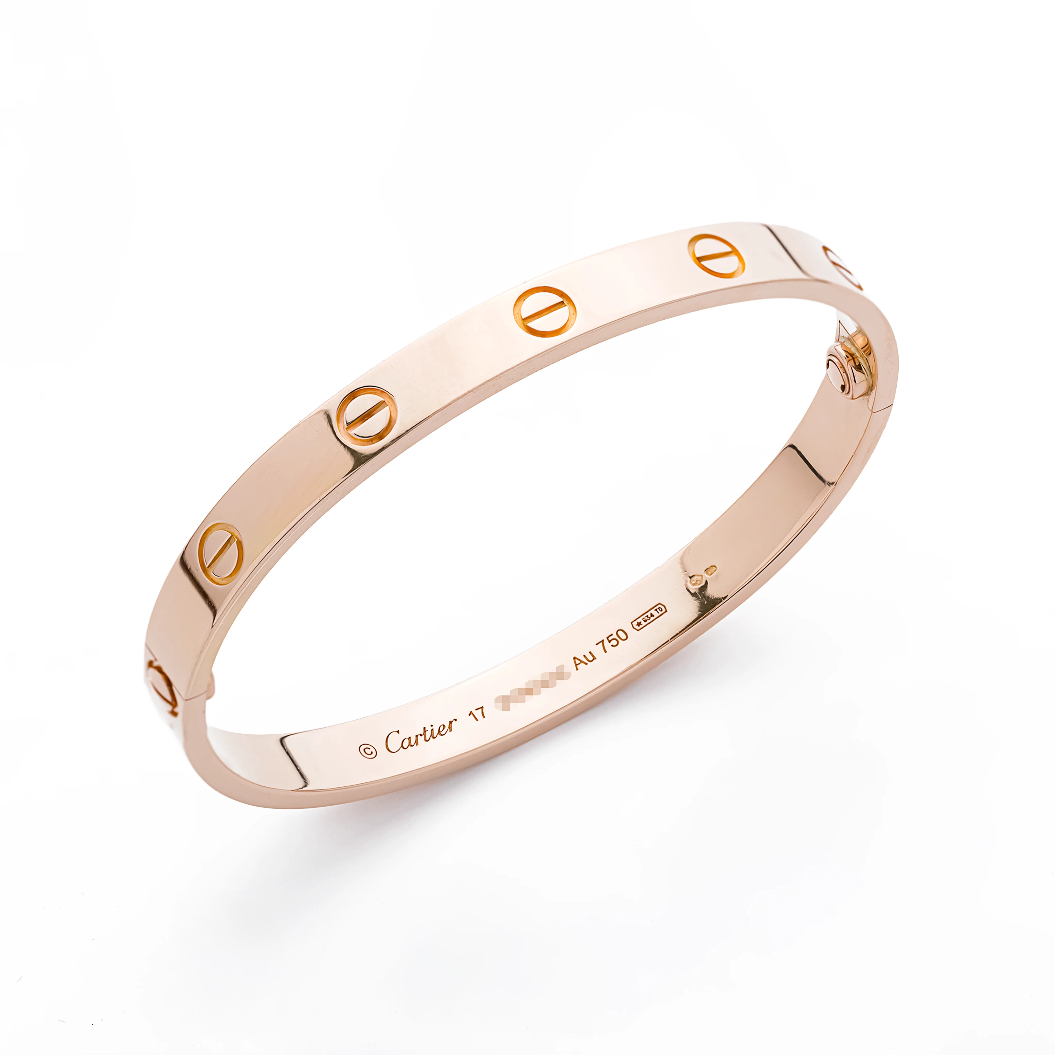 Cartier Love bracelet in rose gold opened at the hinge, displayed next to its matching gold screwdriver, on a white background.