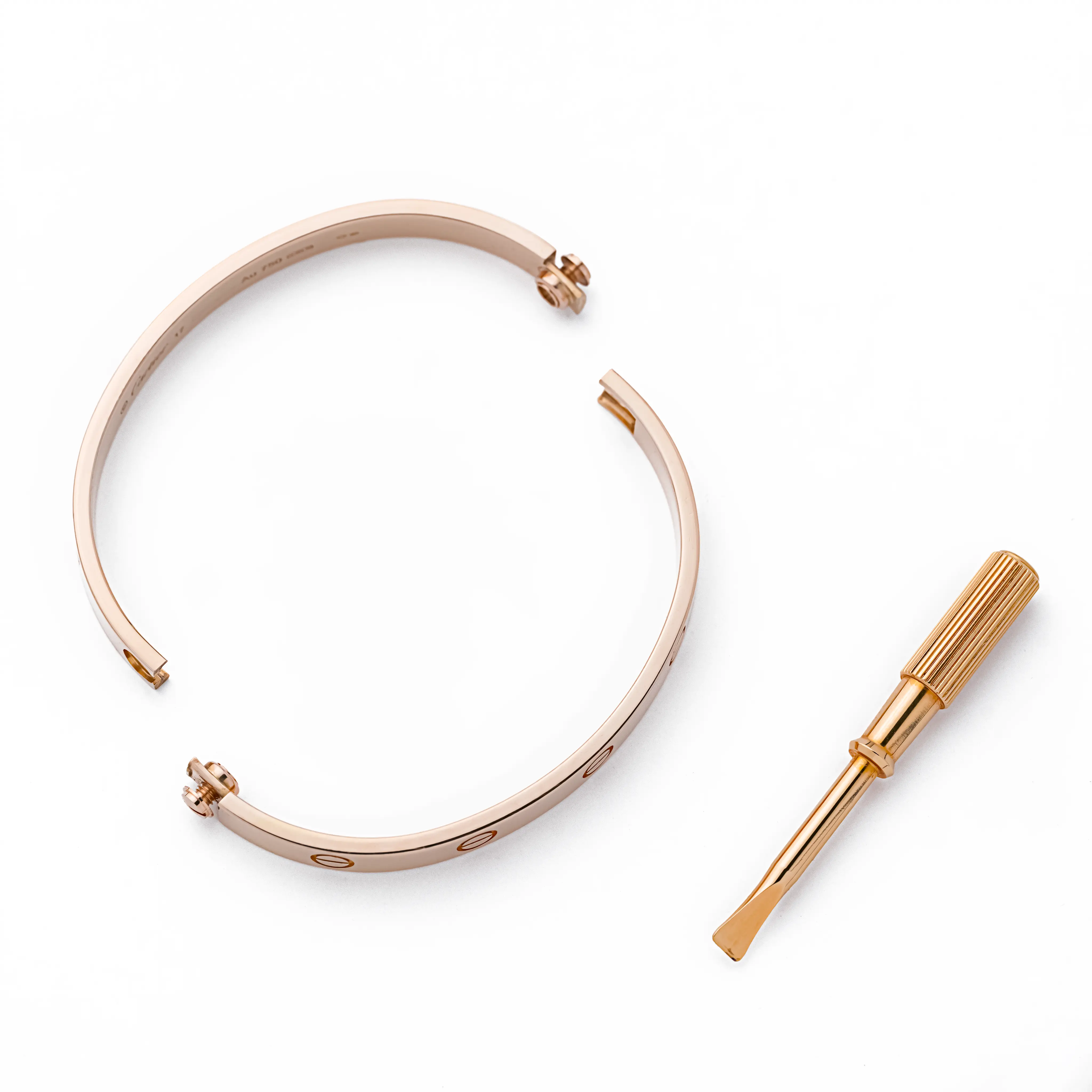 Angled view of the Cartier Love bracelet in 18k rose gold, showing the screw motifs and inner "Cartier 17 Au 750" hallmark engraving, on a white background.