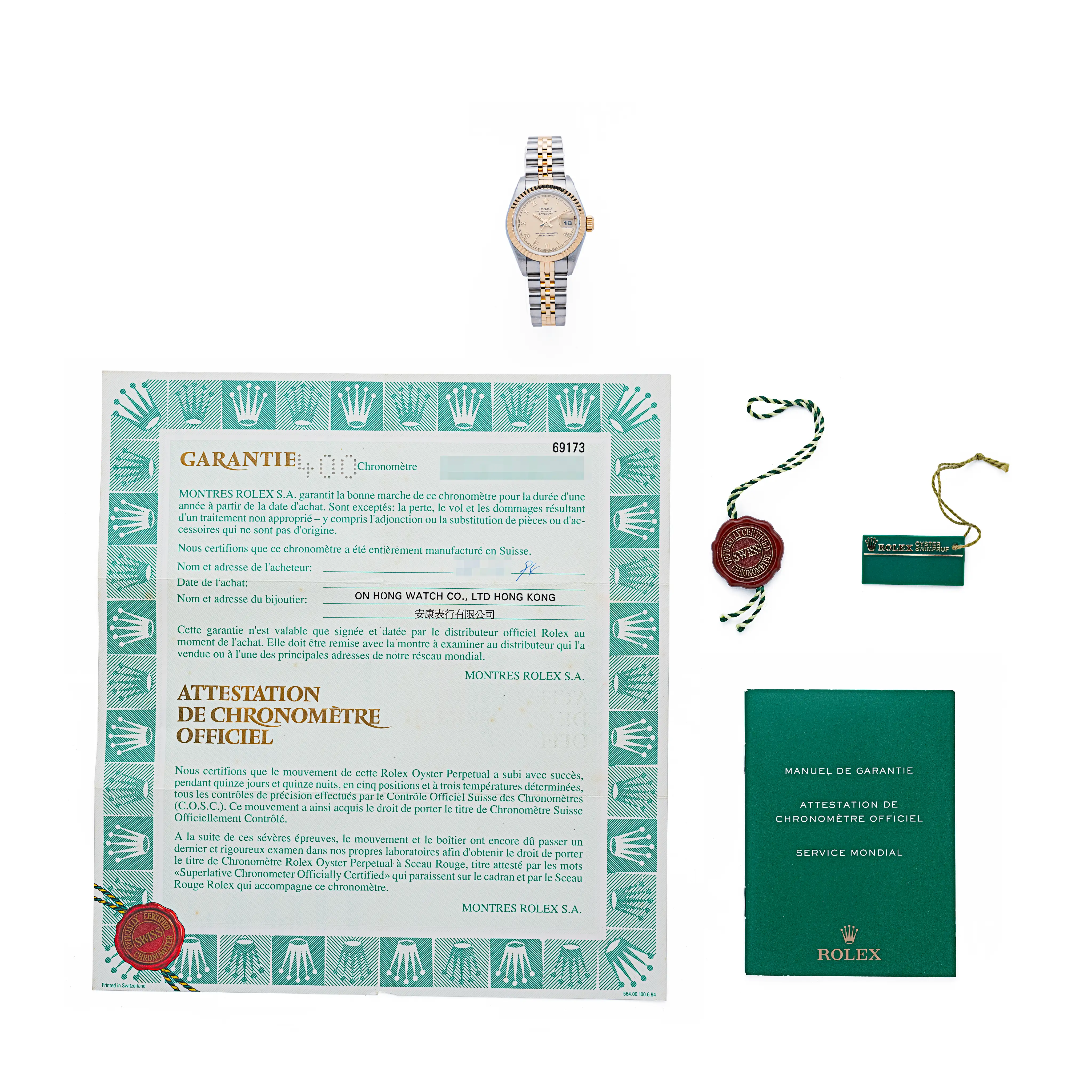 Rolex Lady-Datejust 69173 with its guarantee certificate, chronometer booklet, hang tags, and red wax seal.