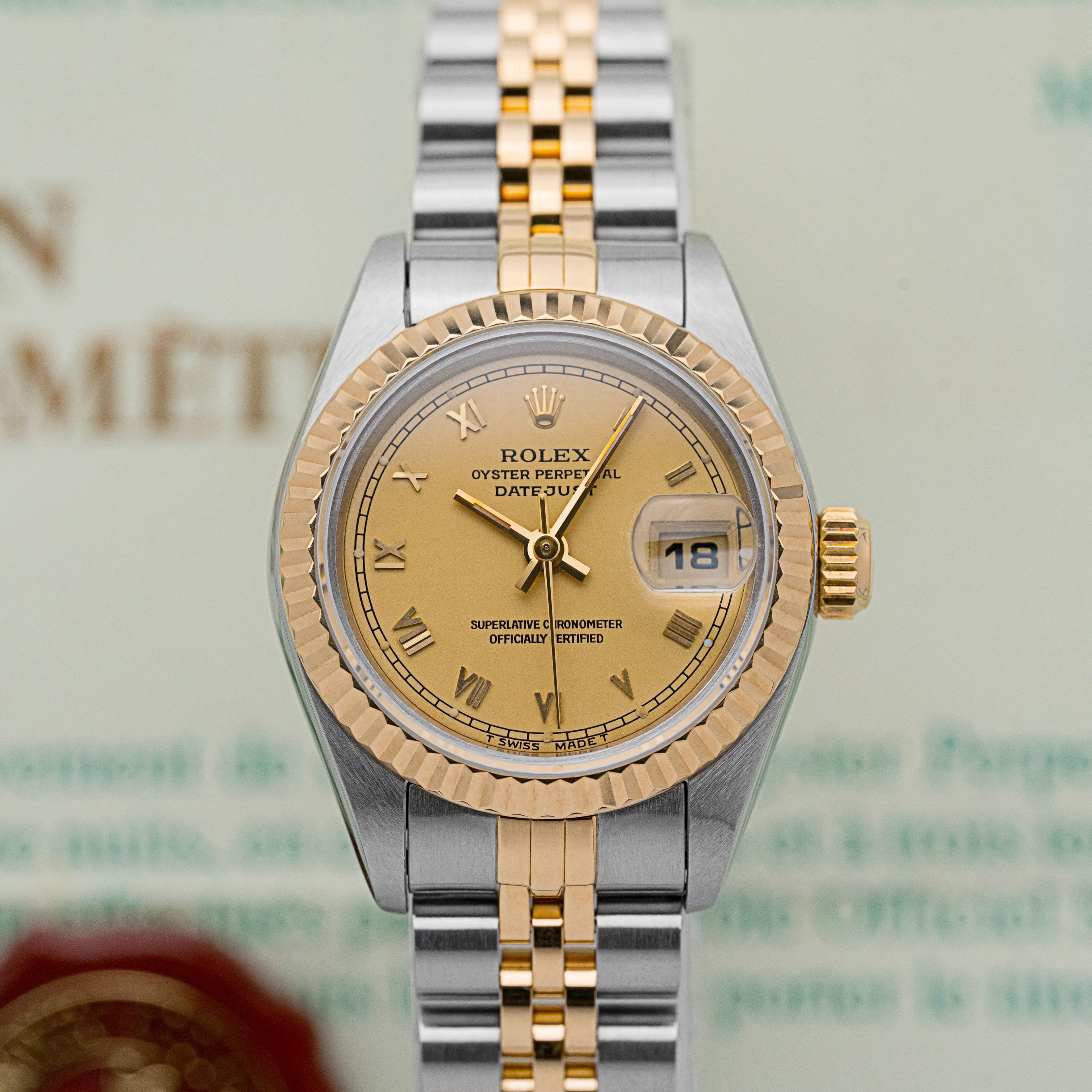 Front view of the Rolex Lady-Datejust 69173 with champagne Roman dial and fluted gold bezel.