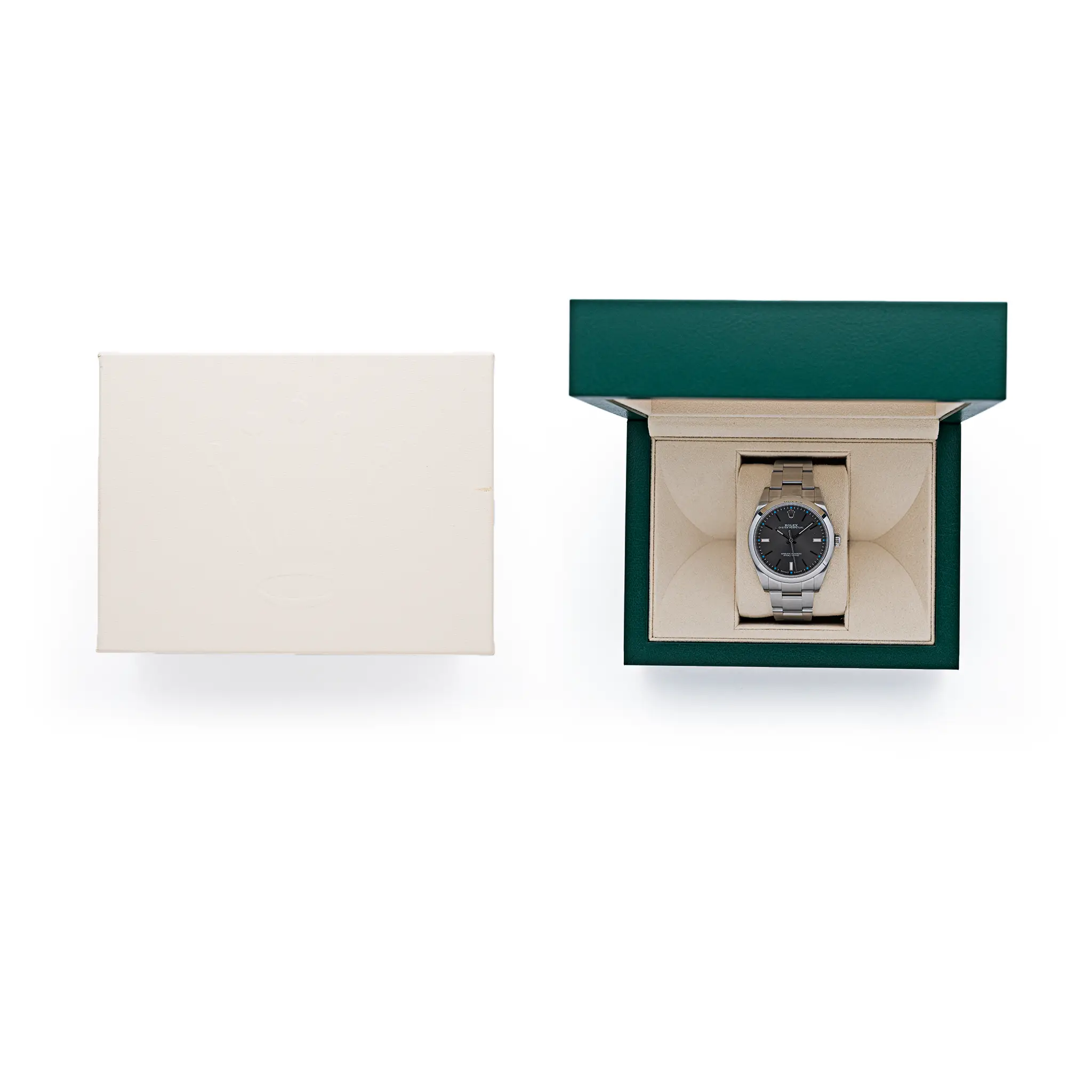The Rolex Oyster Perpetual 39 (114300) presented in its green Rolex box alongside the cream outer box, on a white background.