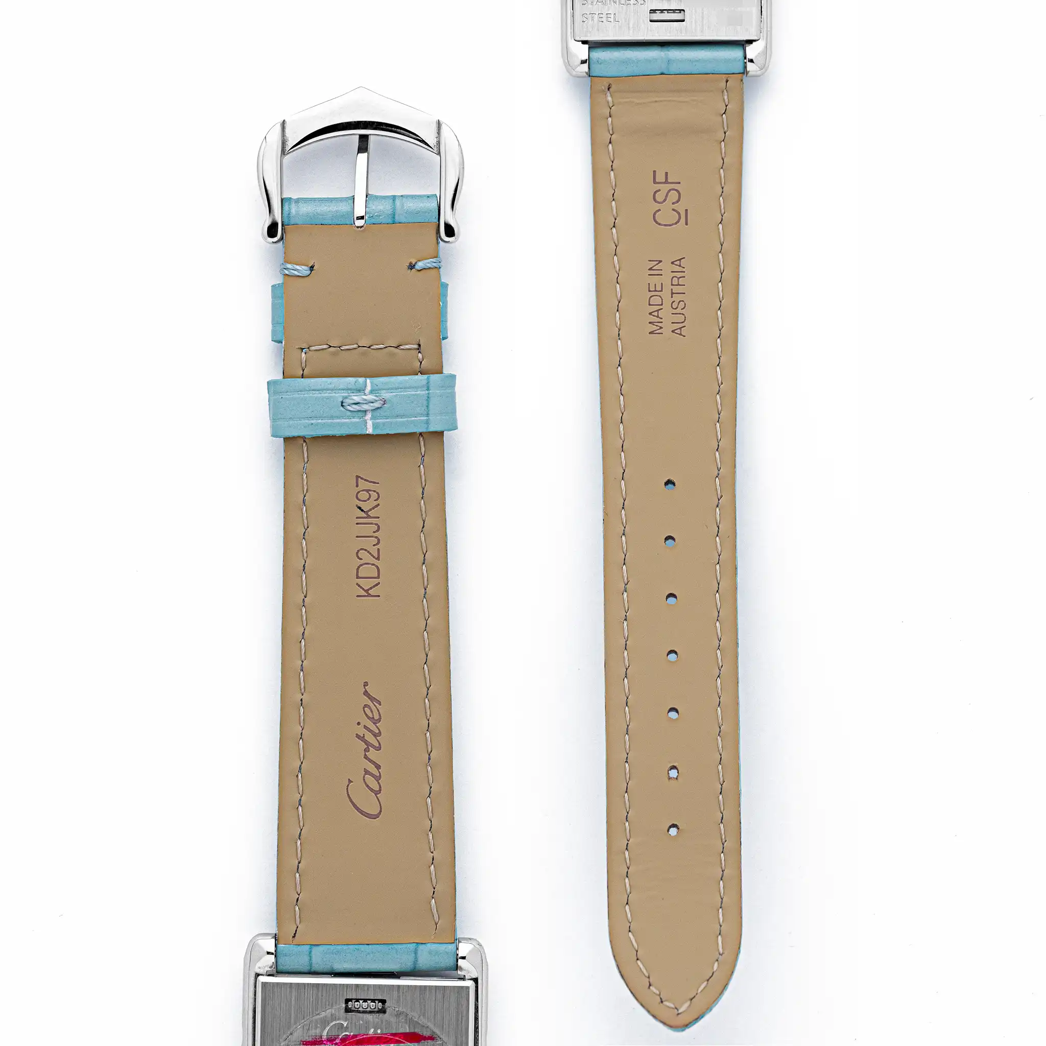 Underside of the light blue Cartier alligator strap showing "Cartier KD2JJK97" and "Made in Austria CSF" markings.